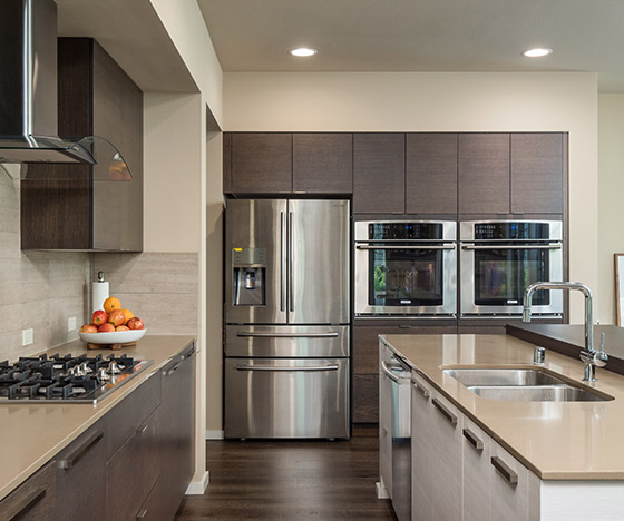 Modern kitchen with brown slab cabinets and an island