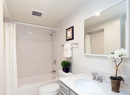 Guest bathroom with subway tile shower and white cabinet vanity