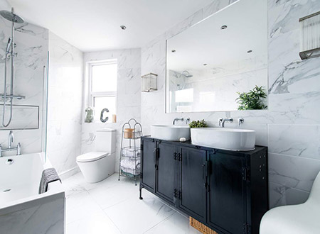 Marble bathroom with smaller double vessel sink vanity and shower bathtub combination