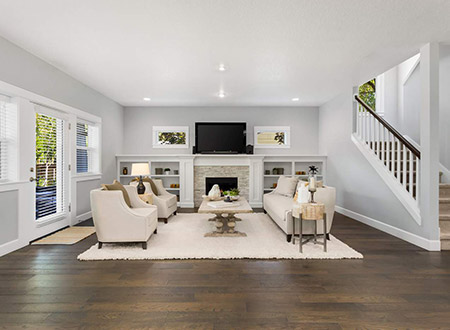 Large living room with fireplace that has a television above it