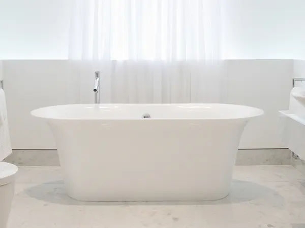 A freestanding tub in a white bathroom remodeling in Washington