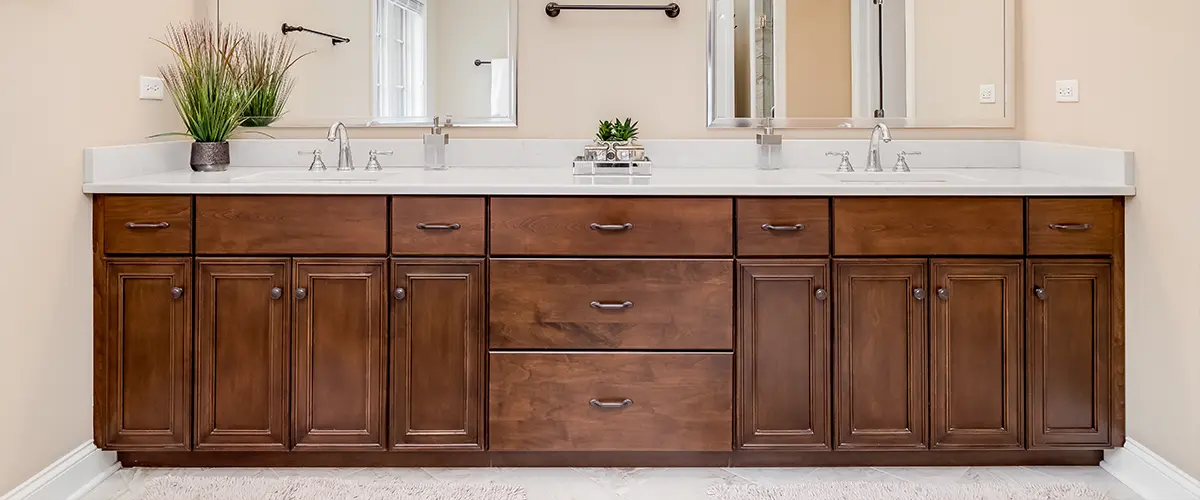 A large wood vanity with dark pulls