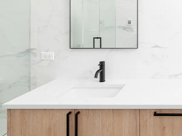 Marble countertop on a vanity with dark features