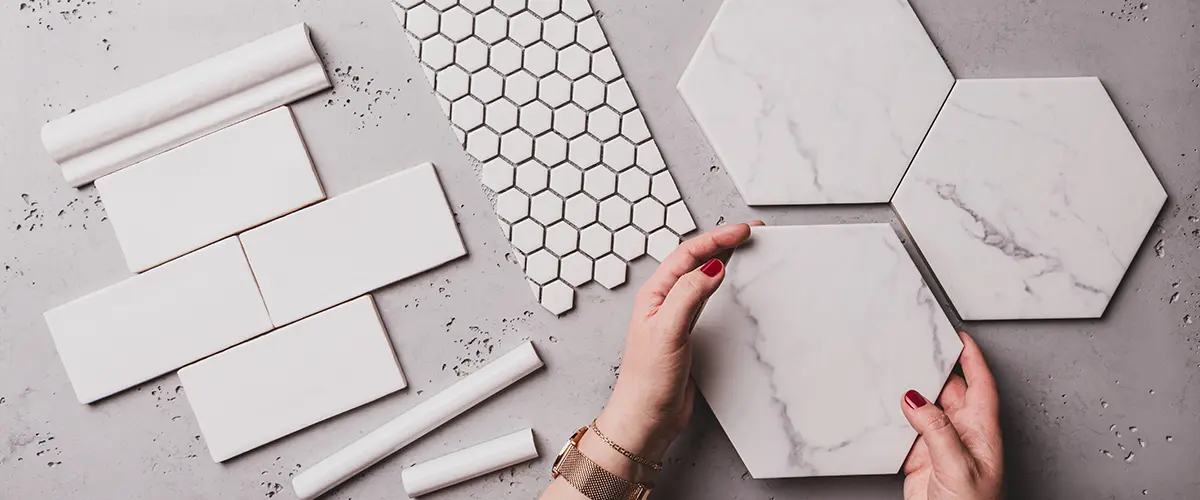Woman's hands selecting different shapes and styles of tile