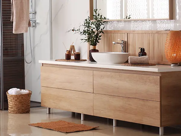 Wood vanity with four large drawers and a plant on it
