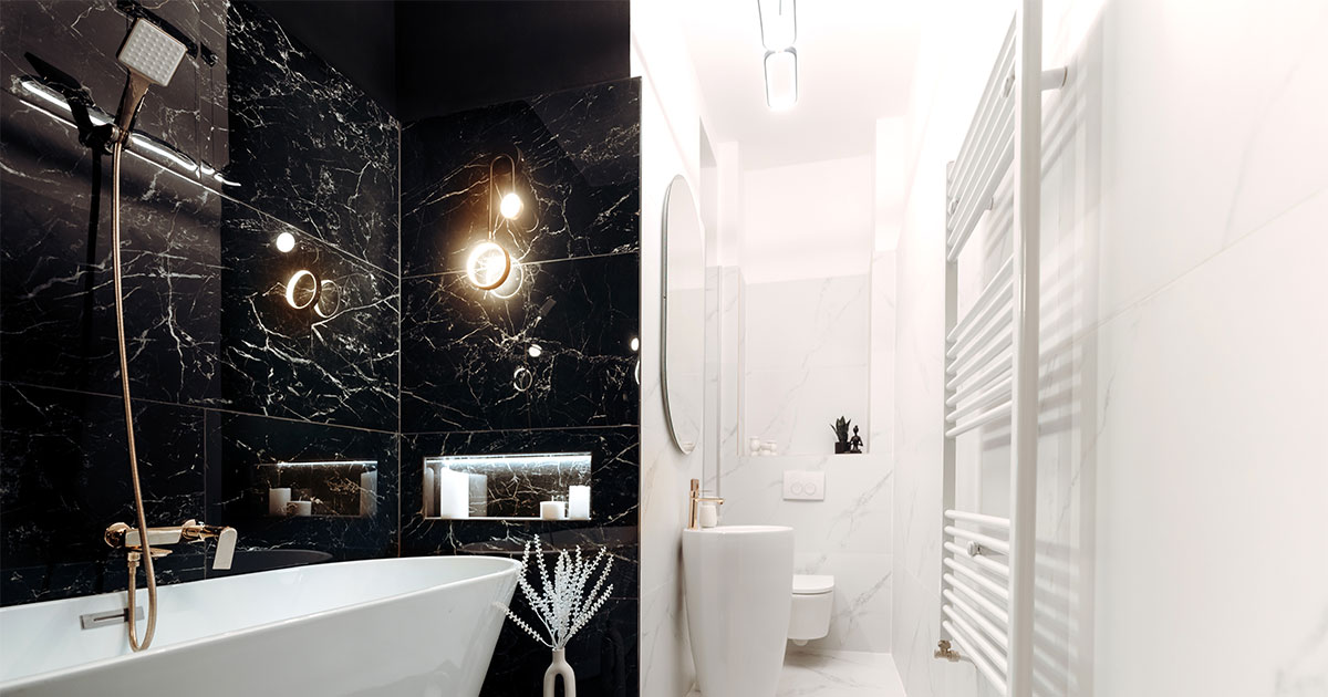 A shower and tub combo in a black and white bathroom