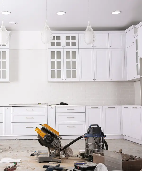 White kitchen cabinets in a space being remodeled