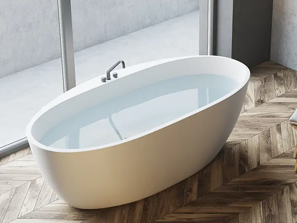 A freestanding tub on hardwood floors