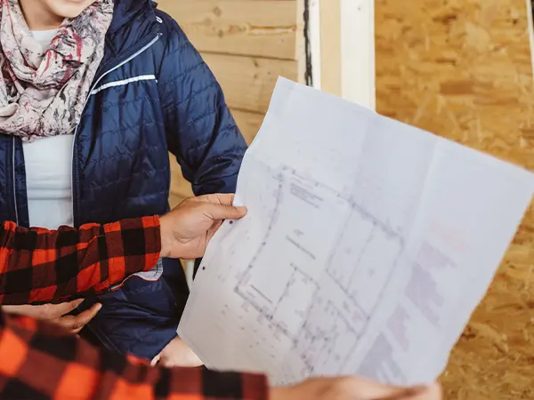 Two persons looking at a home plan.