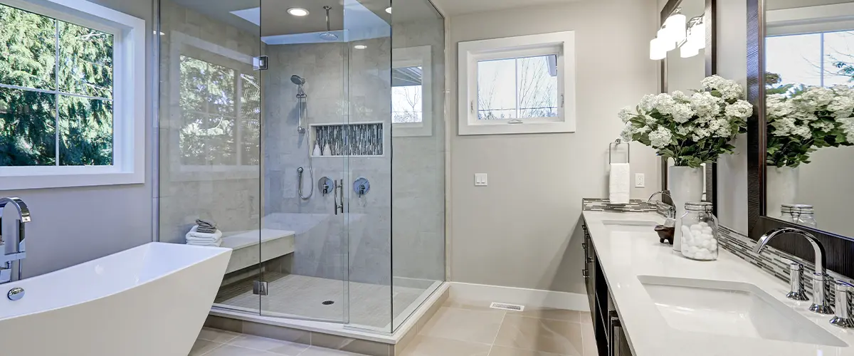 Lynnwood, WA bathroom remodel with glass shower and modern dual sinks.