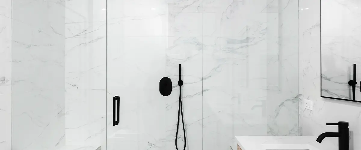 Solid surface shower walls with black fixtures