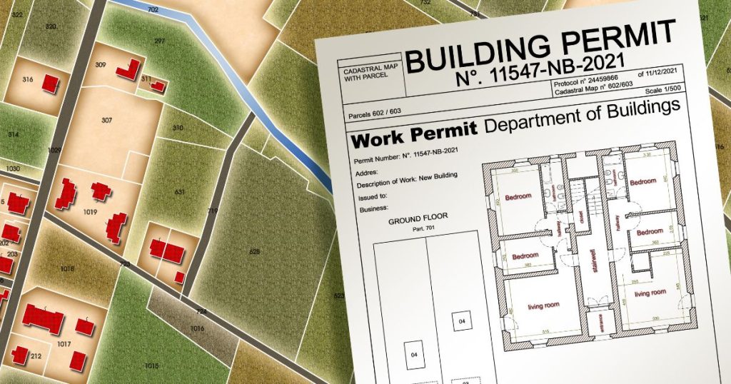 A close-up of a building work permit document placed over a map or planning layout.