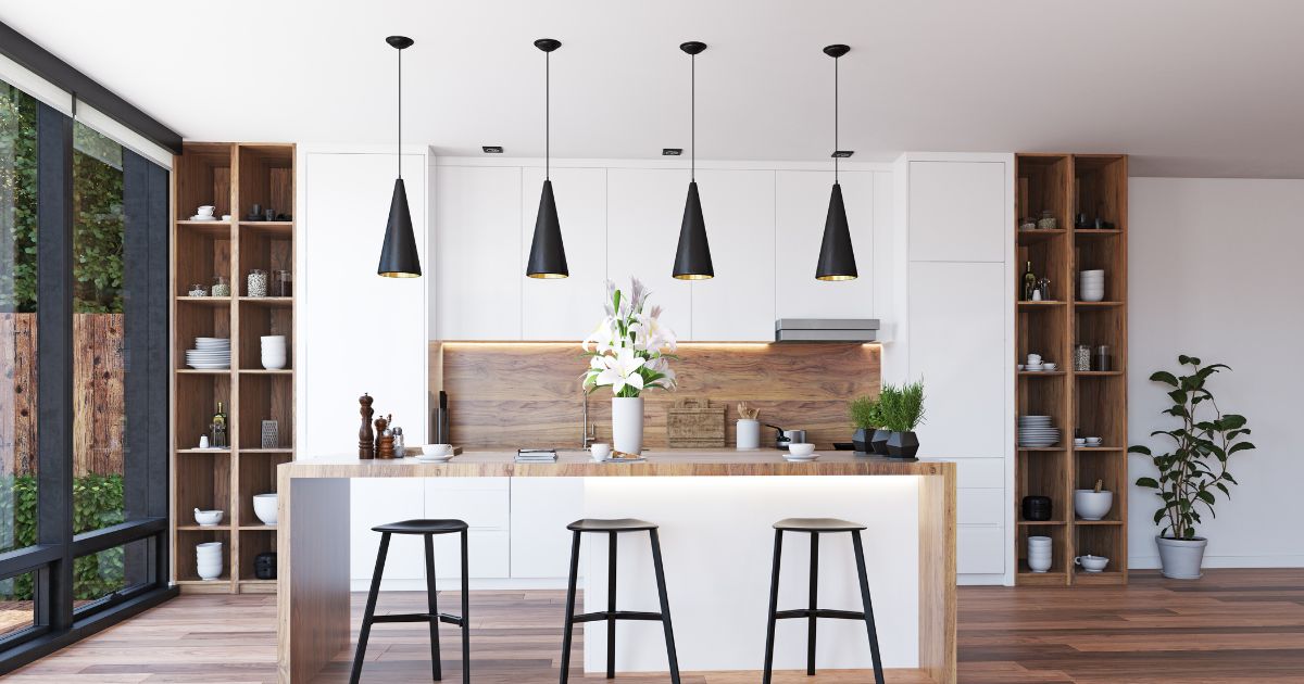 A luxury modern kitchen remodeling project in Litchfield Park, AZ, featuring a white waterfall island, black pendant lights, and wooden shelving.