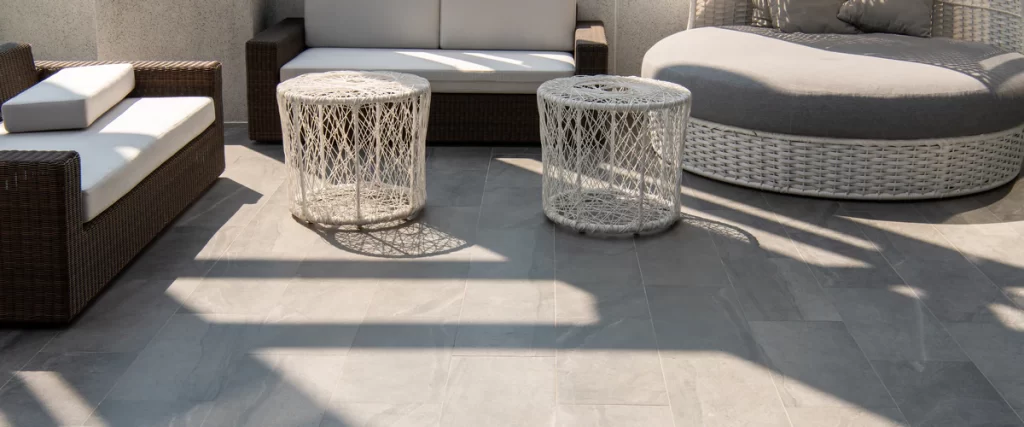 Close-up of heat resistant ceramic tile being installed in a sun-drenched room to maintain cool temperatures.