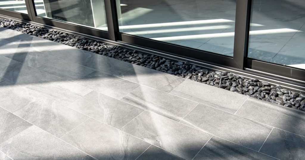 A side-by-side comparison of ceramic tile vs LVP luxury vinyl plank flooring installed in an Arizona living space.