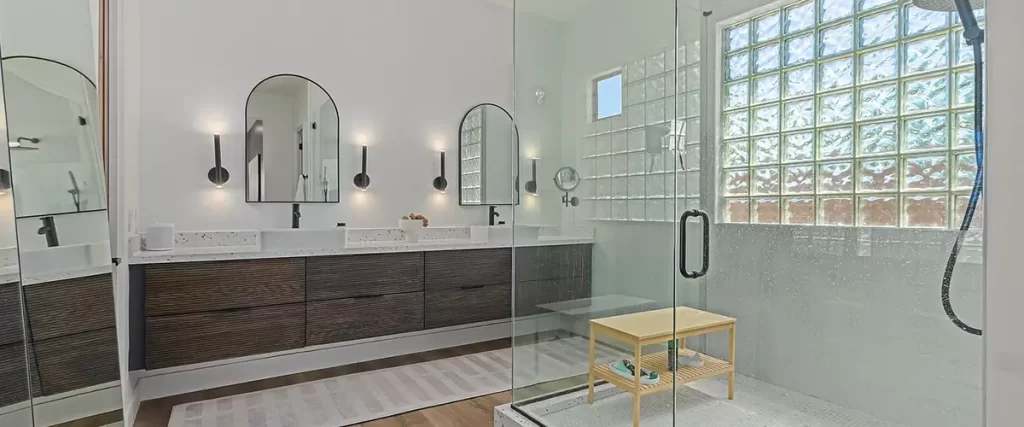 Luxury walk-in shower remodel with glass enclosure, double vanity, and modern bathroom design